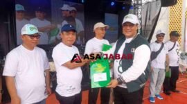 Kepala Kanwil Kemenag Jabar, H. Dudu Rohman, tengah menyerahkan piagam penghargaan kepada Kepala Kemenag Kabupaten Ciamis, H. Asep Lukman Hakim.