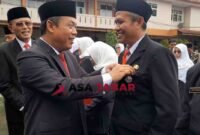 Kepala Kemenag Kabupaten Ciamis, H. Asep Lukman Hakim, M.Si menyematkan tanda kehormatan dari Presiden RI kepada Drs. E. Zenal Muttaqin, M.Pd.I. (kanan).
