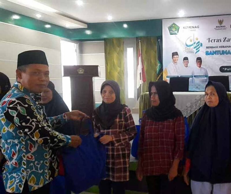 Kepala Kemenag, H. Asep Lukman Hakim tengah memberikan bantuan kepada penerima manfaat.